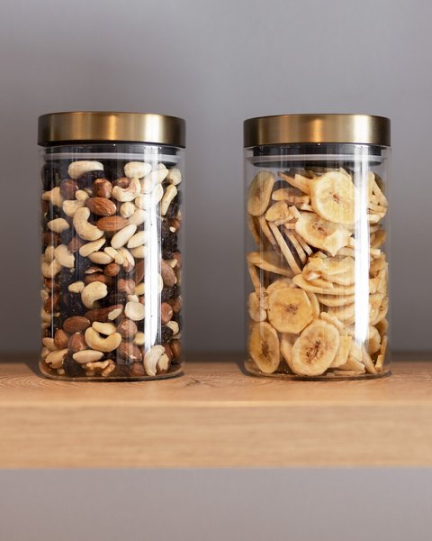 Pictures from Sportalm Four jars with nuts and banana chips on a wooden shelf