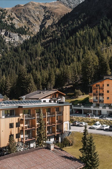 Pictures from Sportalm Hotel buildings surrounded by mountains and forests on a sunny day