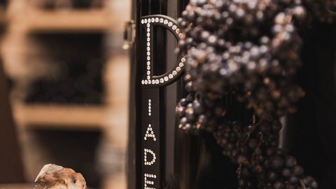 Pictures from Sportalm Wine bottle next to grapes and cork in a warm setting