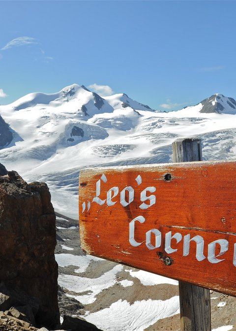 Pictures from Sportalm Wooden sign Leo's Corner with snowy mountains and blue sky background