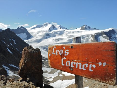 Pictures from Sportalm Wooden sign Leo's Corner with snowy mountains and blue sky background