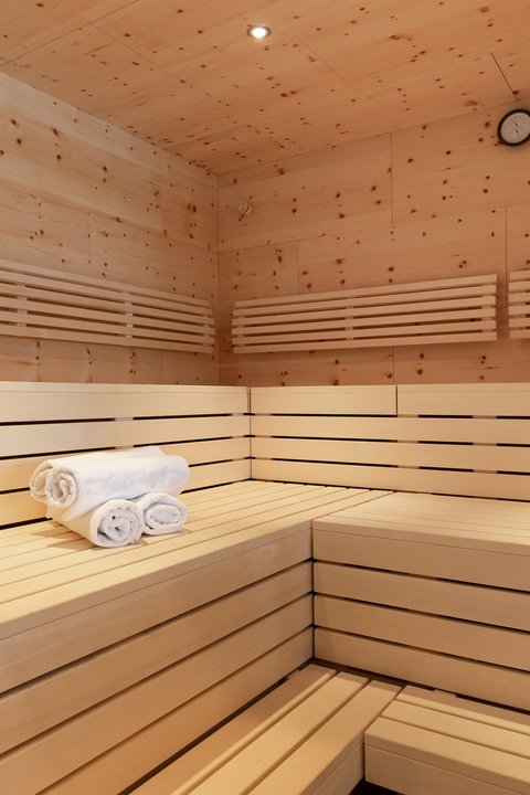 Pictures from Sportalm Inside a sauna with wooden benches, towels, and a wooden bucket