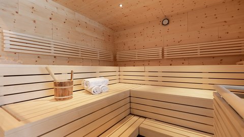 Pictures from Sportalm Inside a sauna with wooden benches, towels, and a wooden bucket