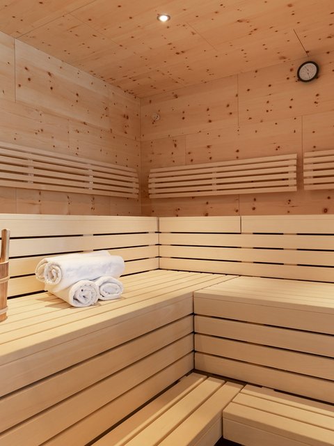 Bilder aus der Sportalm Innenraum einer Sauna mit Holzbank, Handtüchern und Holzeimer