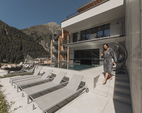 Pictures from Sportalm Woman in robe by the pool area of a mountain hotel
