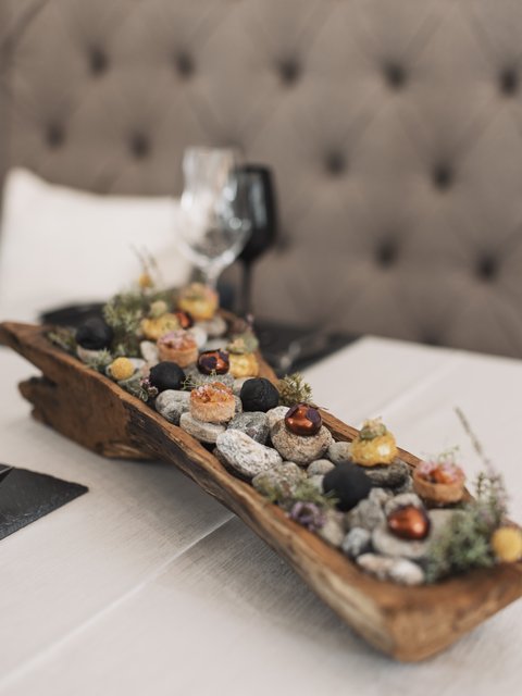 Pictures from Sportalm Appetizers served on stones in a rustic wooden tray