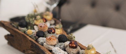 Pictures from Sportalm Appetizers served on stones in a rustic wooden tray