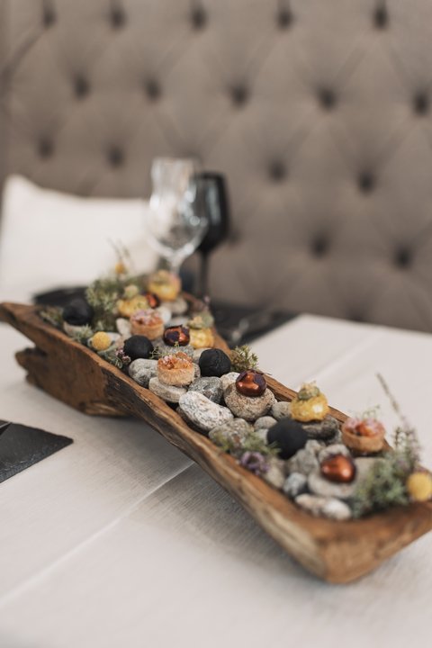 Pictures from Sportalm Appetizers served on stones in a rustic wooden tray