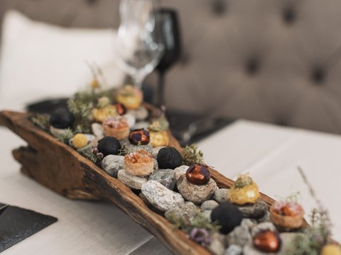 Pictures from Sportalm Appetizers served on stones in a rustic wooden tray