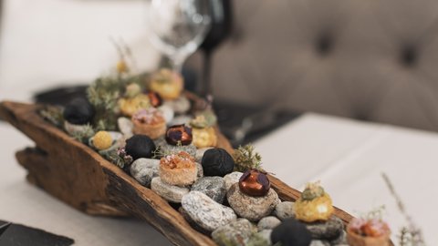 Pictures from Sportalm Appetizers served on stones in a rustic wooden tray