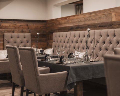 Pictures from Sportalm Elegant dining table with chairs and dark gray tablecloth in cozy restaurant