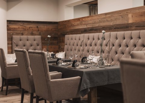 Pictures from Sportalm Elegant dining table with chairs and dark gray tablecloth in cozy restaurant