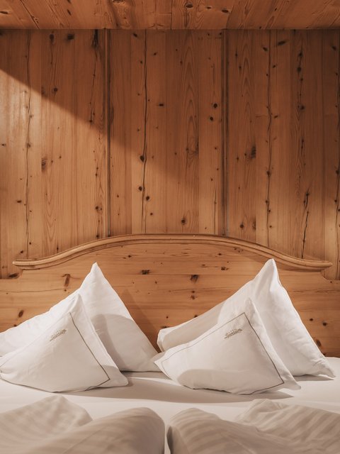 Pictures from Sportalm Cozy wooden bed with white pillows and nightstands with lamps