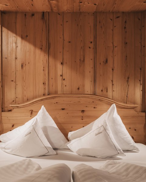 Pictures from Sportalm Cozy wooden bed with white pillows and nightstands with lamps
