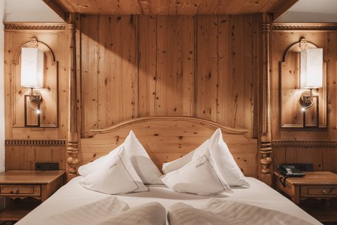 Pictures from Sportalm Cozy wooden bed with white pillows and nightstands with lamps