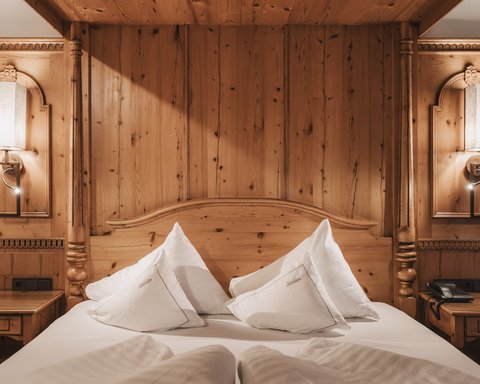 Pictures from Sportalm Cozy wooden bed with white pillows and nightstands with lamps