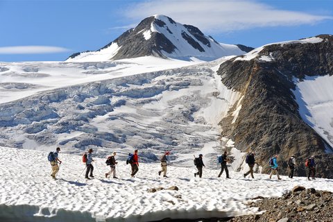 Pictures from Sportalm Group of hikers on snowy mountain trail with mountain in background