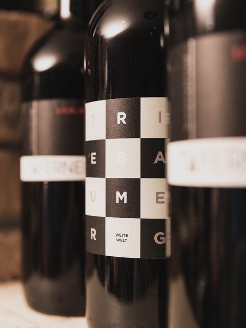 Pictures from Sportalm Close-up of wine bottles with modern labels against brick wall