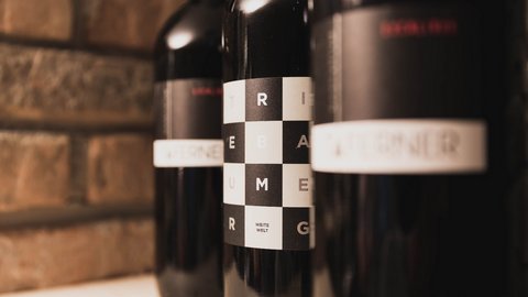 Pictures from Sportalm Close-up of wine bottles with modern labels against brick wall