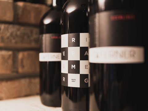 Pictures from Sportalm Close-up of wine bottles with modern labels against brick wall