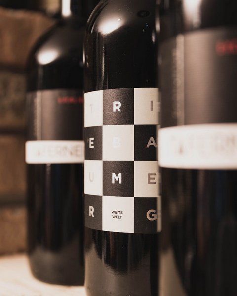 Pictures from Sportalm Close-up of wine bottles with modern labels against brick wall