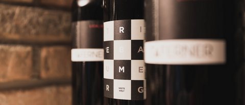 Pictures from Sportalm Close-up of wine bottles with modern labels against brick wall