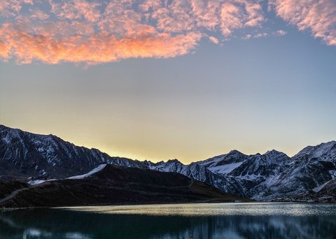 Pictures from Sportalm Mountain lake with reflection and pink clouds at sunset