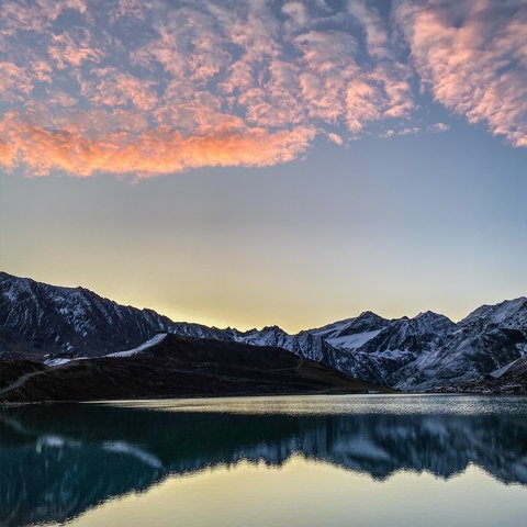 Pictures from Sportalm Mountain lake with reflection and pink clouds at sunset