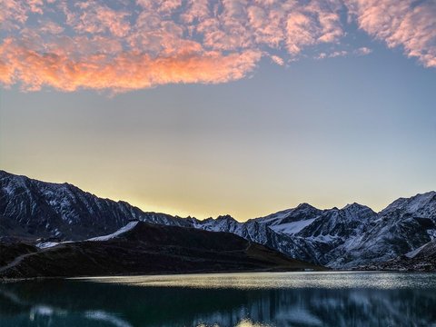 Pictures from Sportalm Mountain lake with reflection and pink clouds at sunset