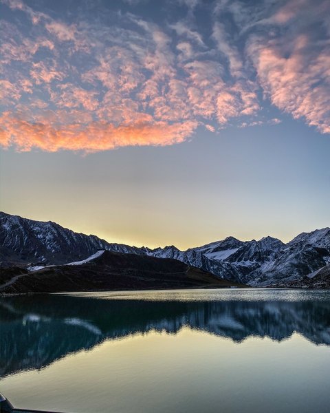 Pictures from Sportalm Mountain lake with reflection and pink clouds at sunset