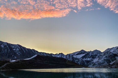 Pictures from Sportalm Mountain lake with reflection and pink clouds at sunset