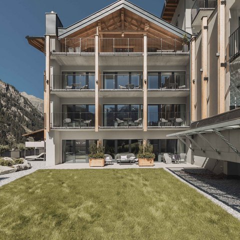 Pictures from Sportalm Modern hotel building with balconies in front of mountains and green lawn