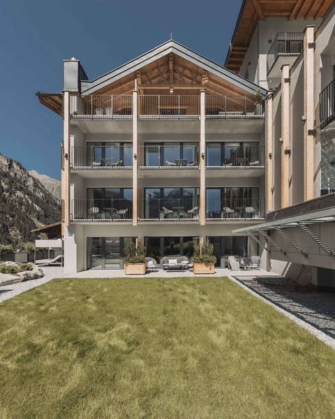 Pictures from Sportalm Modern hotel building with balconies in front of mountains and green lawn