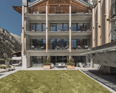Pictures from Sportalm Modern hotel building with balconies in front of mountains and green lawn