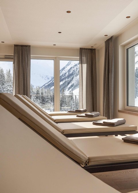 Pictures from Sportalm Lounge chairs with towels by windows overlooking snowy mountains