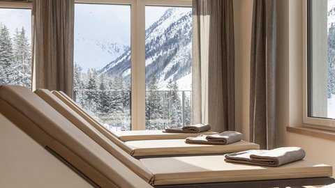 Pictures from Sportalm Lounge chairs with towels by windows overlooking snowy mountains