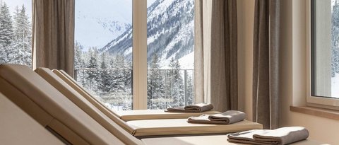 Pictures from Sportalm Lounge chairs with towels by windows overlooking snowy mountains