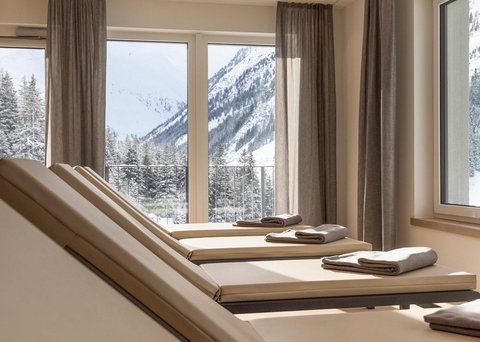 Pictures from Sportalm Lounge chairs with towels by windows overlooking snowy mountains