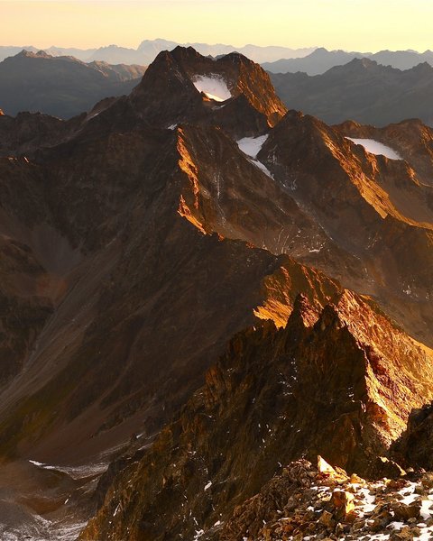 Pictures from Sportalm Mountain peaks bathed in golden sunlight at sunset in the Alps