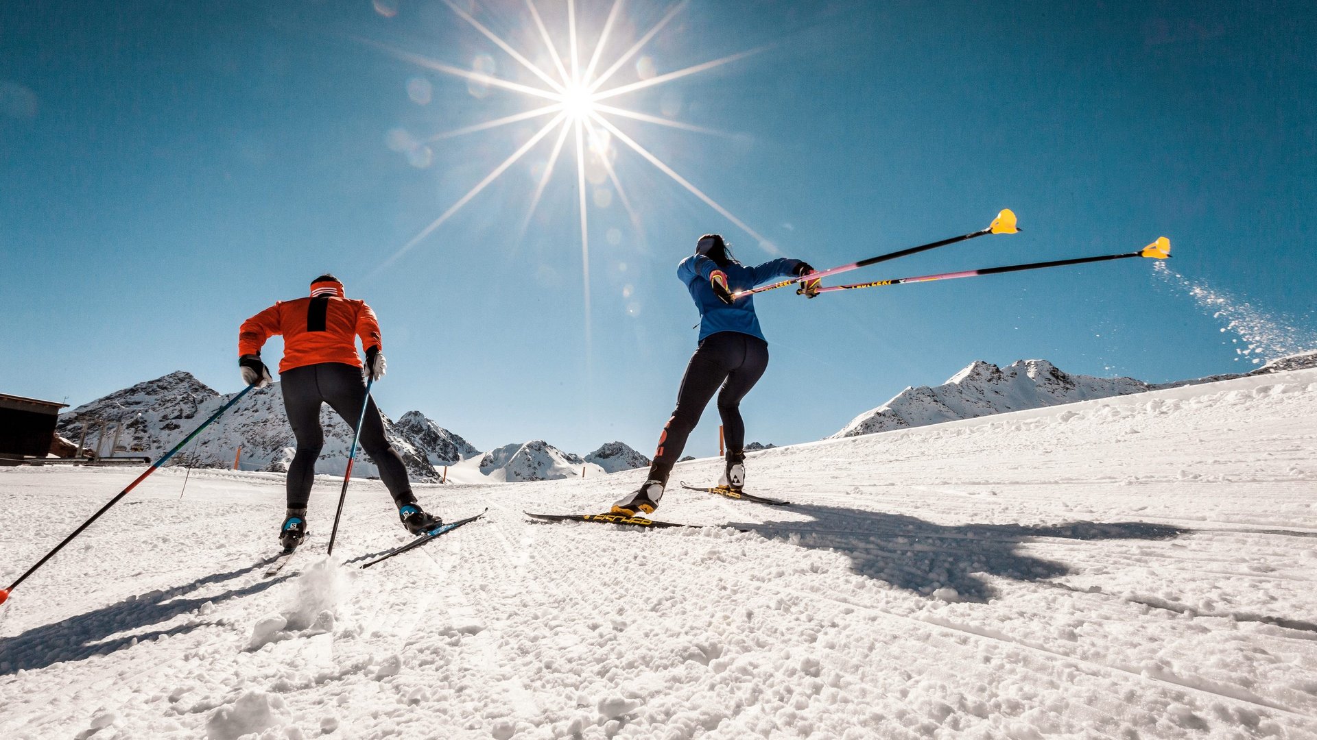 Cross-country skiing in Pitztal Two cross-country skiers on fresh snow in sunlight with mountain background