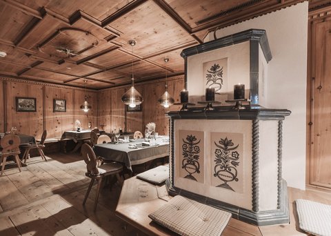 Pictures from Sportalm Cozy wooden room with decorative stove and set dining tables