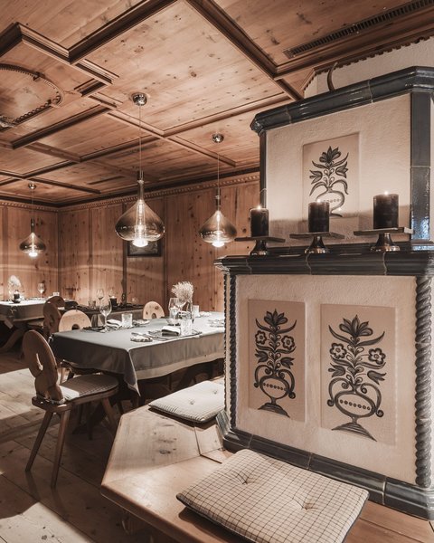 Pictures from Sportalm Cozy wooden room with decorative stove and set dining tables