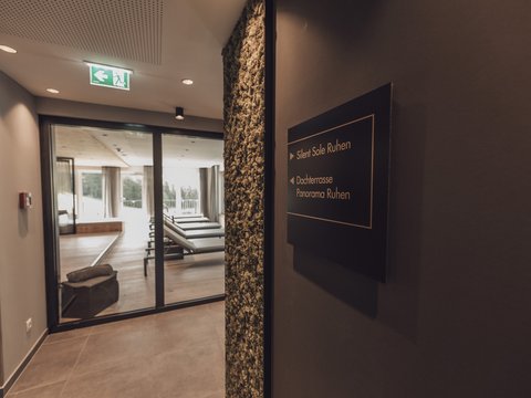 Pictures from Sportalm View of a relaxation area with lounge chairs and a sign pointing to Silent Sole and rooftop terrace