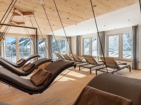 Bilder aus der Sportalm Helle Ruheraum mit Schaukelliegen und Blick auf verschneite Berge