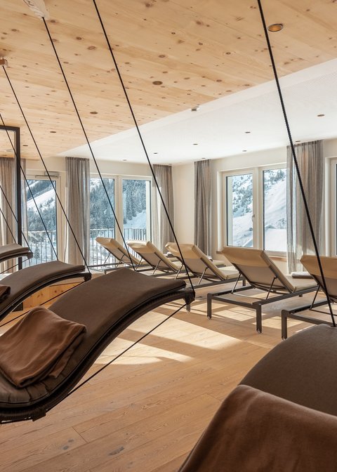 Pictures from Sportalm Bright relaxation room with hanging loungers and snowy mountain view