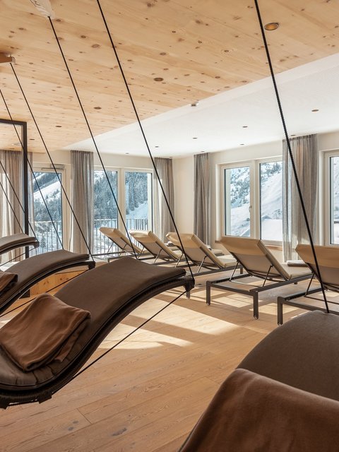 Pictures from Sportalm Bright relaxation room with hanging loungers and snowy mountain view