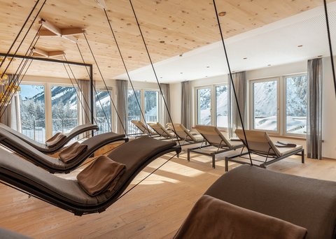 Pictures from Sportalm Bright relaxation room with hanging loungers and snowy mountain view