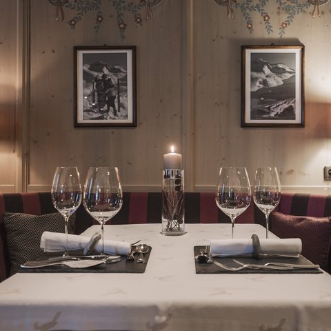 Pictures from Sportalm Cozy dining table with candle, two place settings, and lamps in wooden room