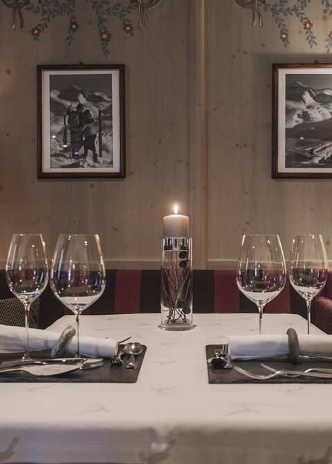 Pictures from Sportalm Cozy dining table with candle, two place settings, and lamps in wooden room