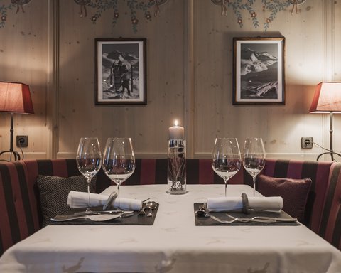 Pictures from Sportalm Cozy dining table with candle, two place settings, and lamps in wooden room